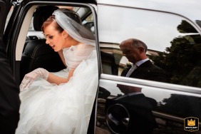 Arriving for her wedding ceremony in Udine, Italy, the bride steps elegantly out of the car, moments before making her grand entrance.
